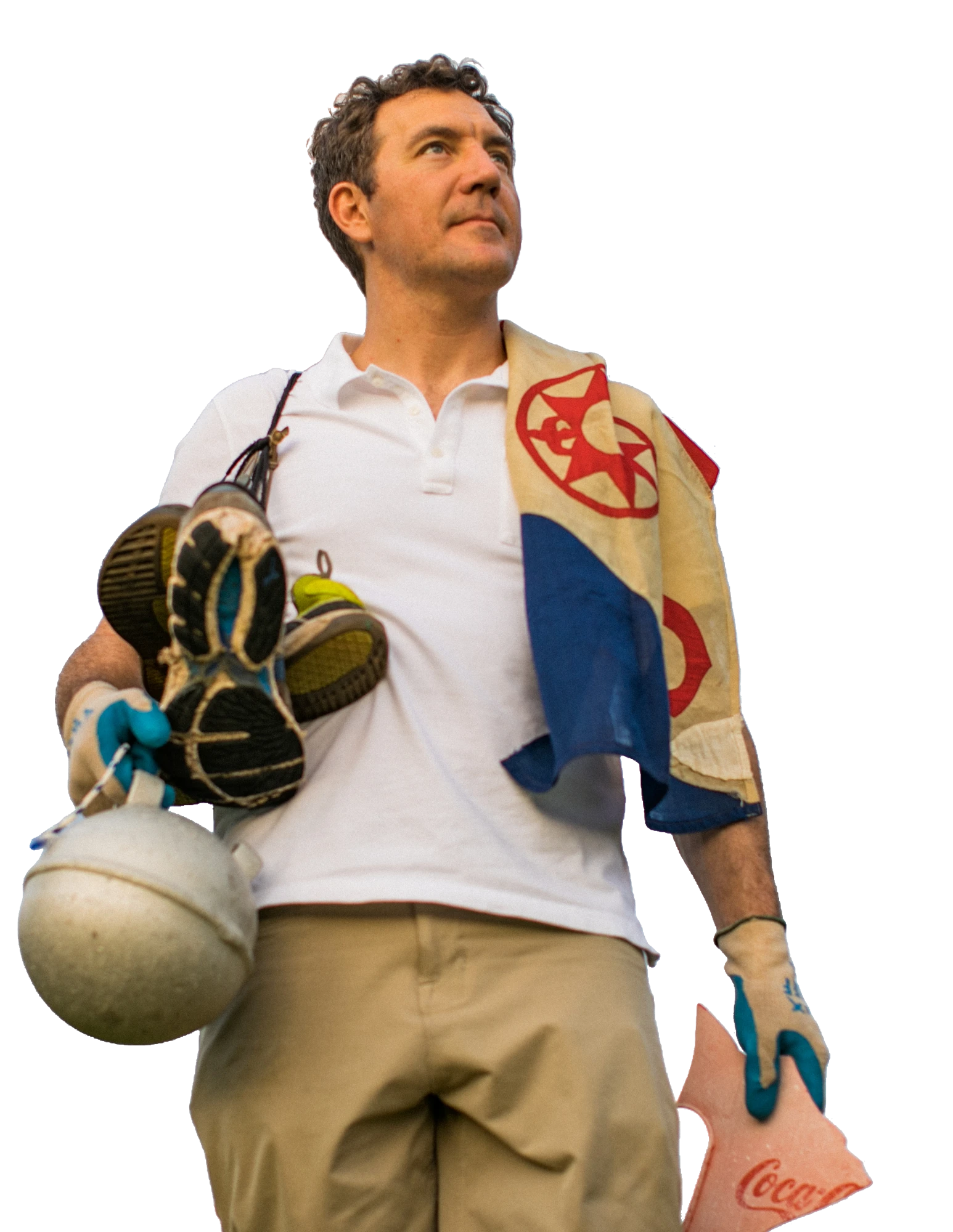 Brett Howell holding trash collected from a cleanup, an Explorers Club flag over his shoulder